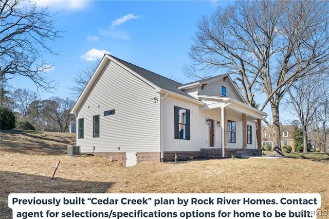 view of side of home with covered porch, central AC, and crawl space