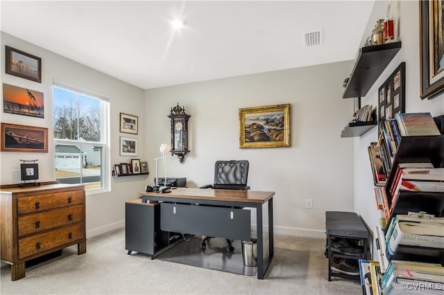 office featuring baseboards, visible vents, and light carpet