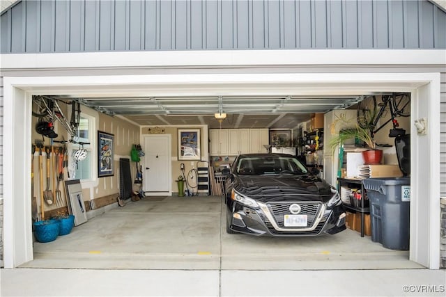 garage featuring a garage door opener and driveway