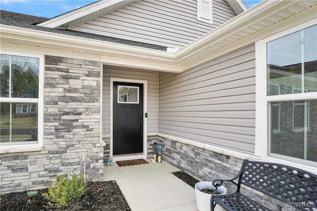 property entrance with stone siding