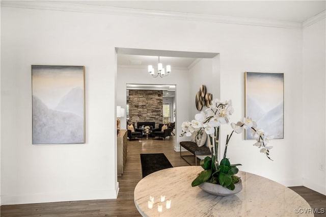 dining room with crown molding, baseboards, an inviting chandelier, and dark wood-style floors