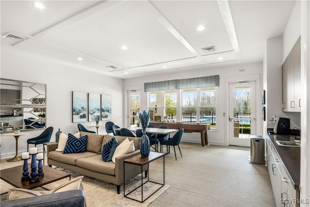 living room with recessed lighting, light colored carpet, and visible vents