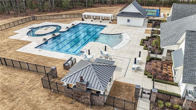 pool with a patio, fence private yard, and a jacuzzi