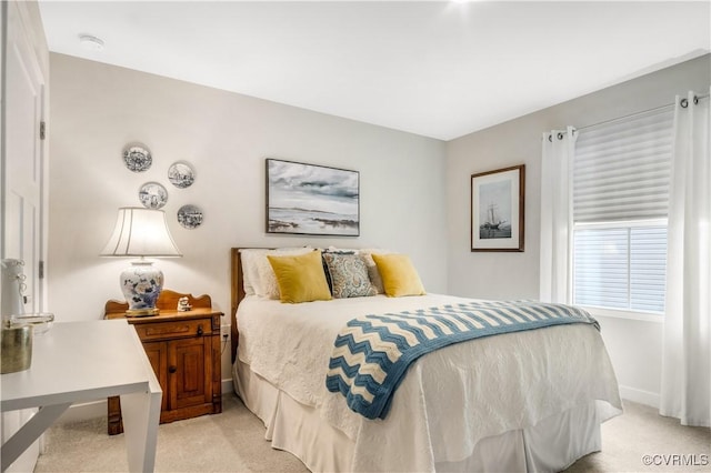 bedroom with baseboards and light carpet