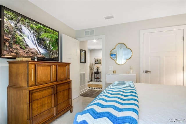 bedroom with baseboards and visible vents