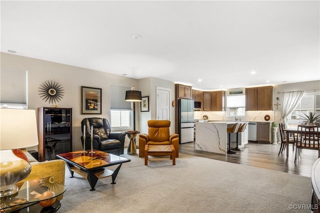 living area with recessed lighting and light wood-style flooring