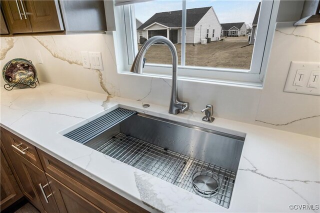details with light stone counters and a sink