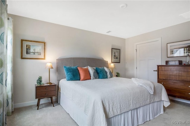 carpeted bedroom featuring baseboards and visible vents