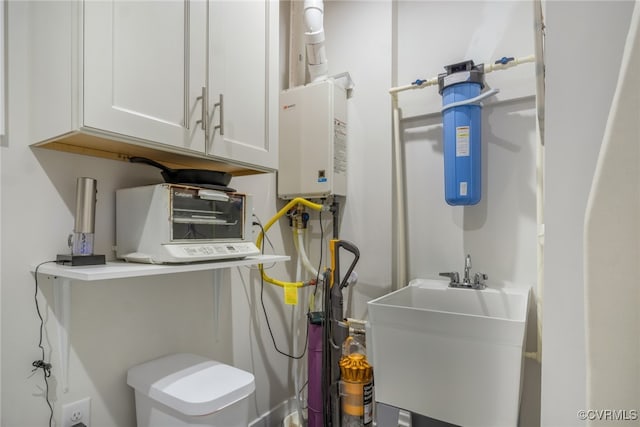 utility room with a sink and water heater