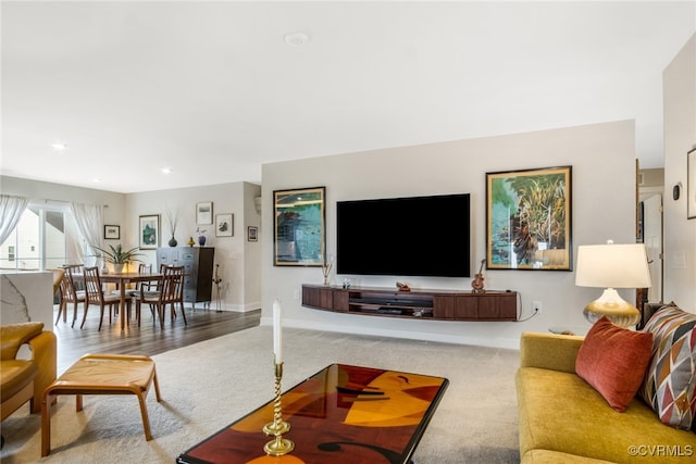 living room with recessed lighting, baseboards, and carpet