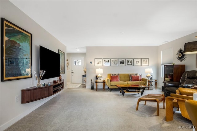 carpeted living area with baseboards