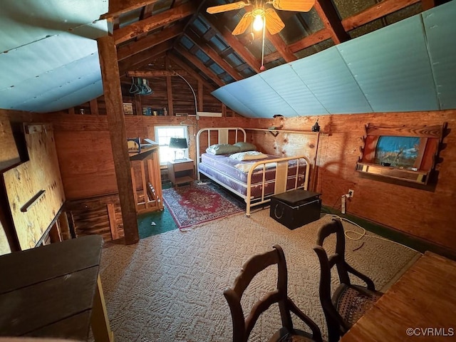 carpeted bedroom featuring lofted ceiling and wooden walls