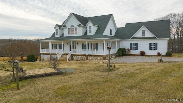 country-style home with a porch and a front lawn