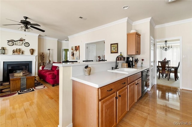 kitchen featuring sink, kitchen peninsula, light wood-type flooring, and dishwasher