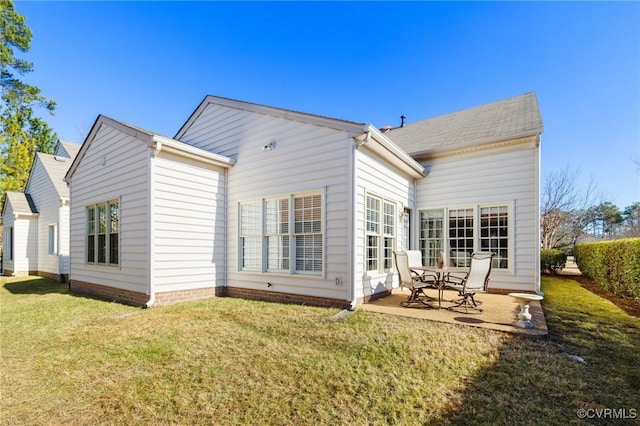 rear view of property featuring a patio and a yard