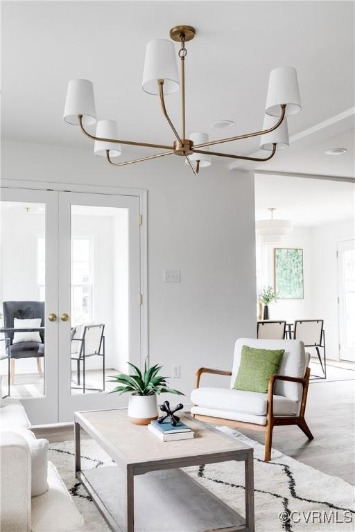 living area featuring light wood-style floors and french doors