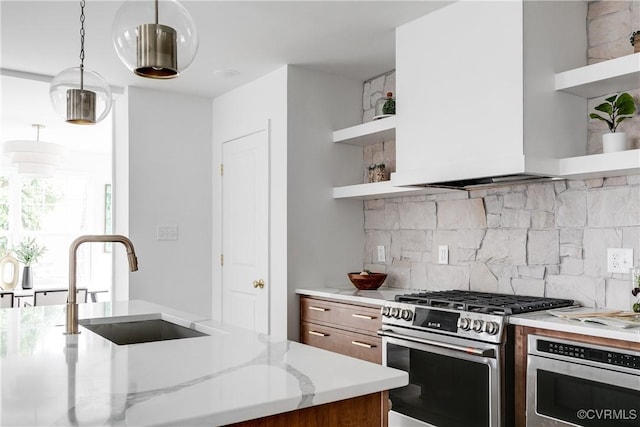 kitchen featuring stainless steel gas stove, tasteful backsplash, oven, open shelves, and a sink