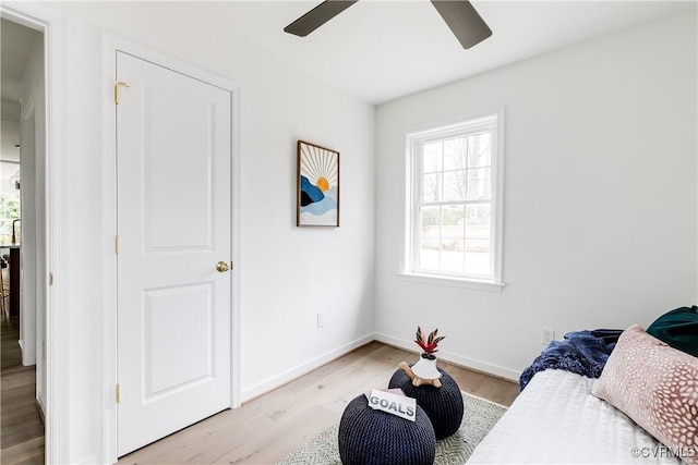 bedroom with baseboards, ceiling fan, and light wood finished floors