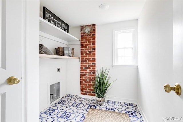 laundry room with laundry area, hookup for an electric dryer, a fireplace, and baseboards