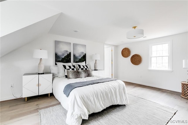 bedroom with baseboards and wood finished floors