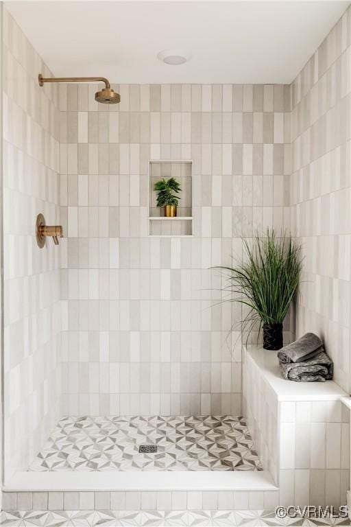 full bathroom with tiled shower