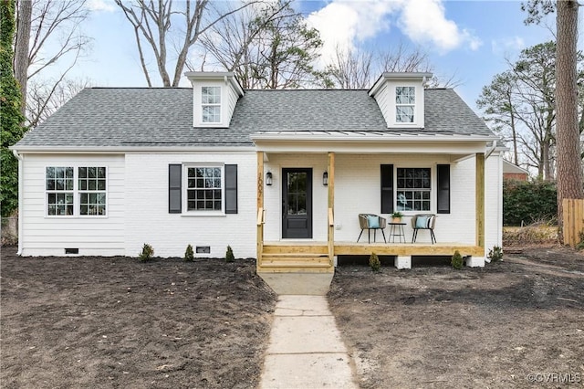 view of front of house with crawl space, brick siding, covered porch, and roof with shingles