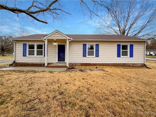 ranch-style home with a front lawn