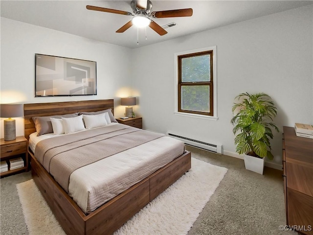 carpeted bedroom with a baseboard radiator and ceiling fan