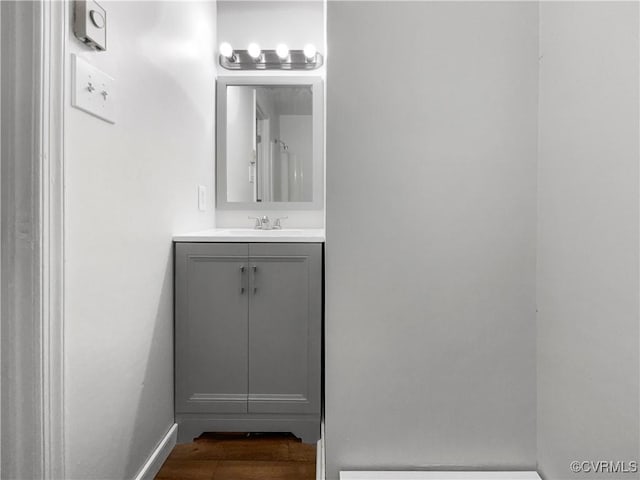 bathroom with hardwood / wood-style flooring and vanity