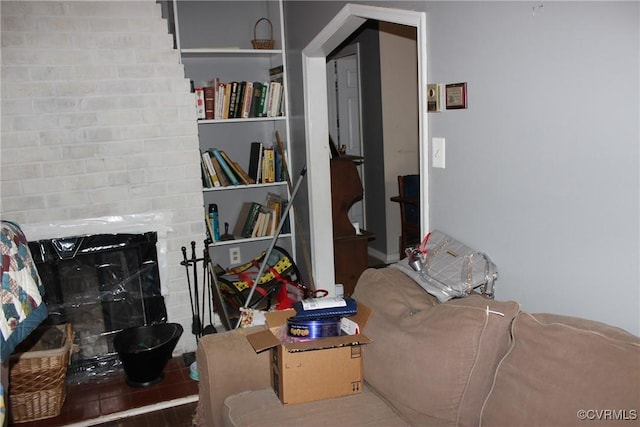 living room with a brick fireplace