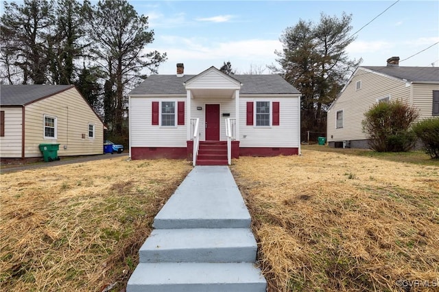 bungalow-style home with a front yard