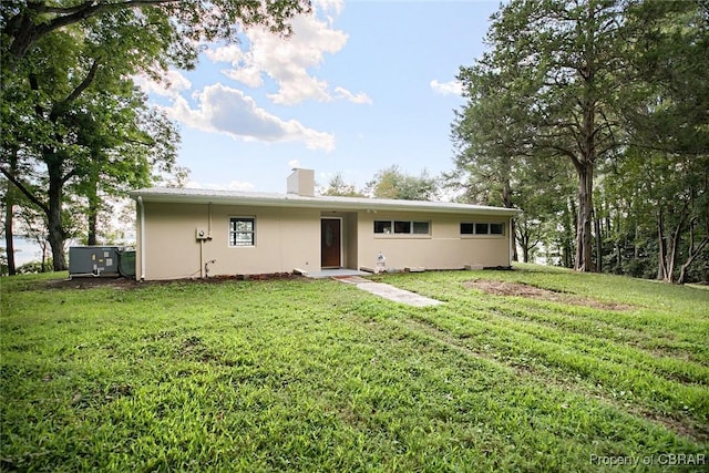 back of property featuring a yard