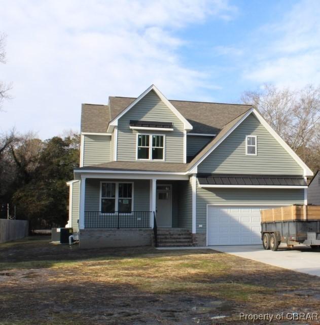 view of front of home featuring a garage and a porch