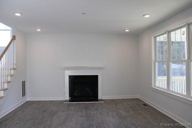 unfurnished living room featuring dark hardwood / wood-style floors