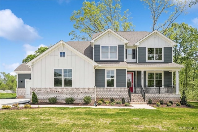 2700 Maidens Rd, Powhatan, VA 23139 - view of front of house featuring board and batten siding, a porch, a front lawn, and brick siding