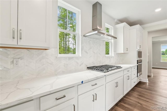2700 Maidens Rd, Powhatan, VA 23139 - kitchen with wall chimney range hood, tasteful backsplash, white cabinets, appliances with stainless steel finishes, and light stone countertops