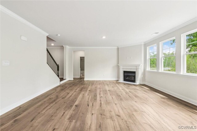 2700 Maidens Rd, Powhatan, VA 23139 - unfurnished living room with crown molding, stairs, a glass covered fireplace, light wood-type flooring, and baseboards