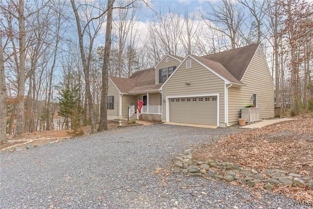 view of front of house featuring a garage and gravel driveway