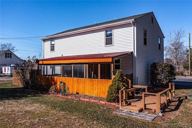 rear view of house with a yard and a deck