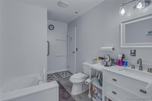 bathroom featuring vanity, toilet, and a tub