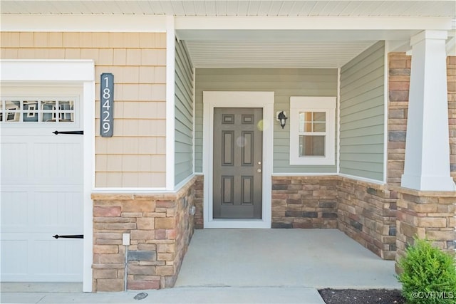 view of exterior entry with a porch