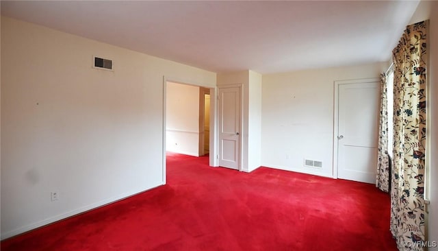 unfurnished bedroom featuring carpet floors, visible vents, and baseboards