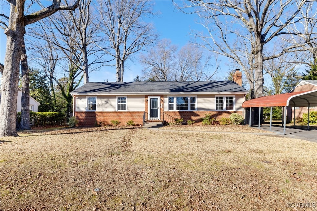 single story home with a front lawn and a carport