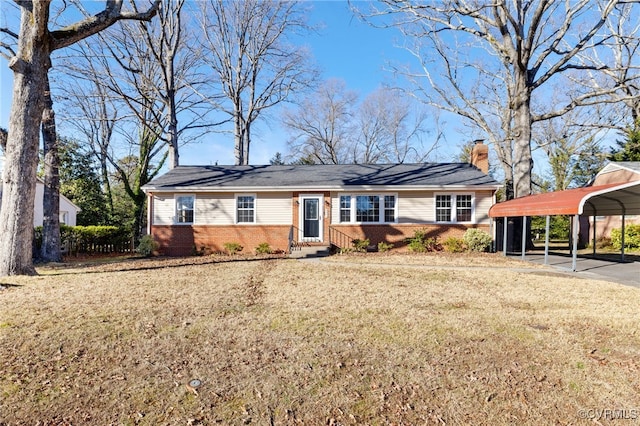 single story home with a front lawn and a carport