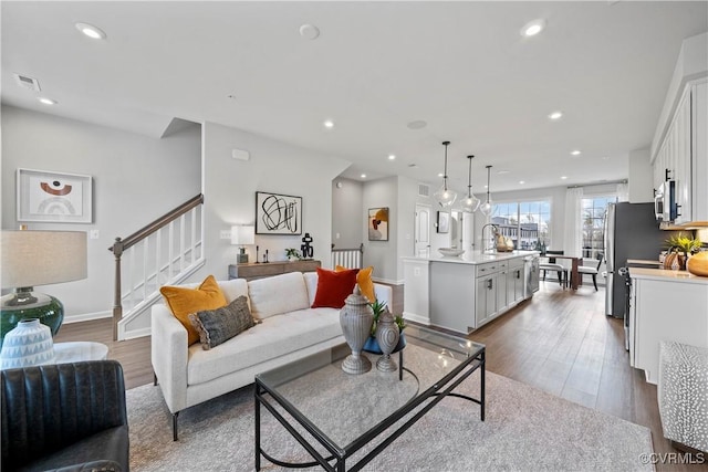 living room featuring sink and wood-type flooring