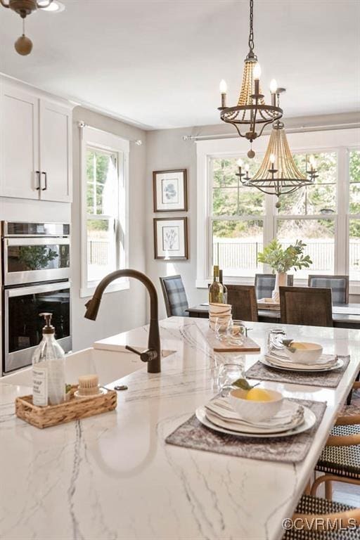 dining area featuring a notable chandelier