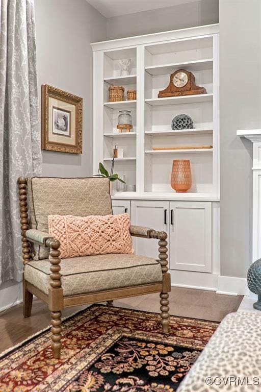 living area featuring baseboards