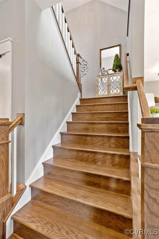 stairs featuring vaulted ceiling