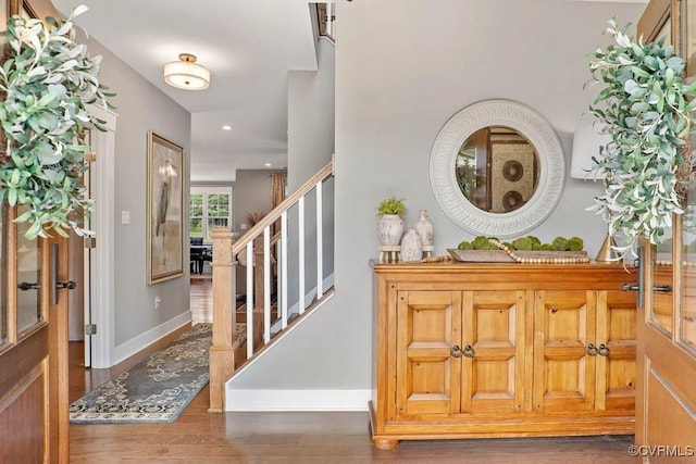 entrance foyer with baseboards, stairway, wood finished floors, and recessed lighting