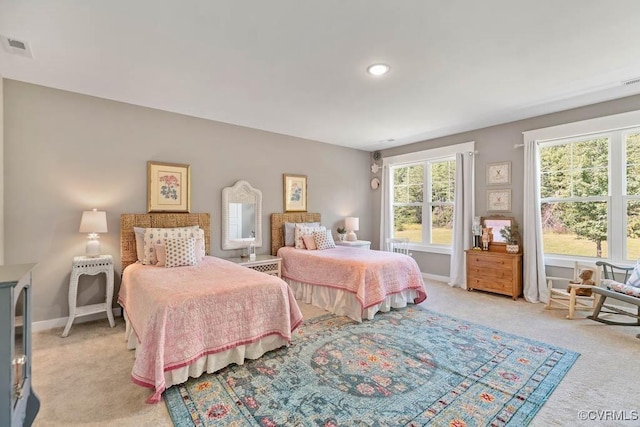 bedroom with light colored carpet, visible vents, and baseboards